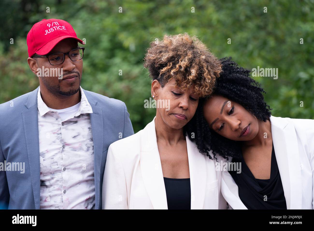 Terrease Aiken, right, leans against her mother, Kimberly, during 