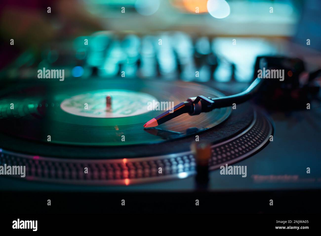DJ turntable plays vinyl records on hip hop party. Professional disc jockey record player on