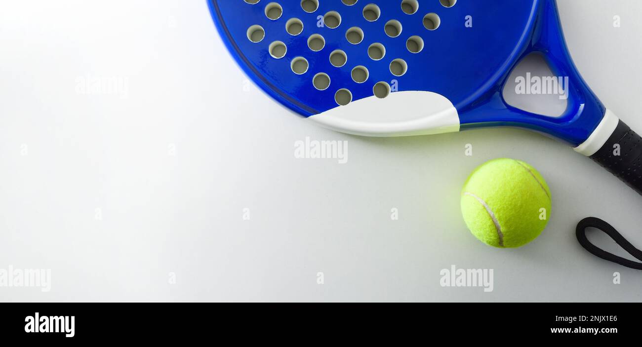 Padel sport background with racket and ball on white background. Top view. Stock Photo