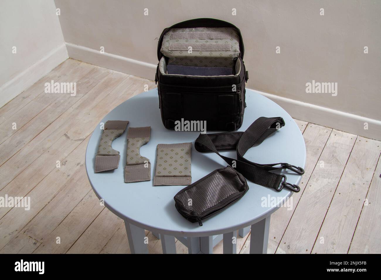 Samsonite camera bag to carry one camera with layout of inserts, the shoulder strap and and a zipped pouch for accessories or even films Stock Photo