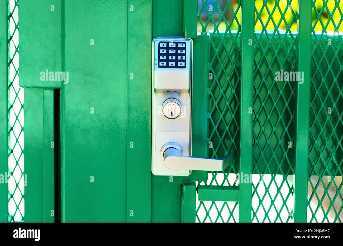 Green fence gate entry lock with keypad, front view Stock Photo Alamy