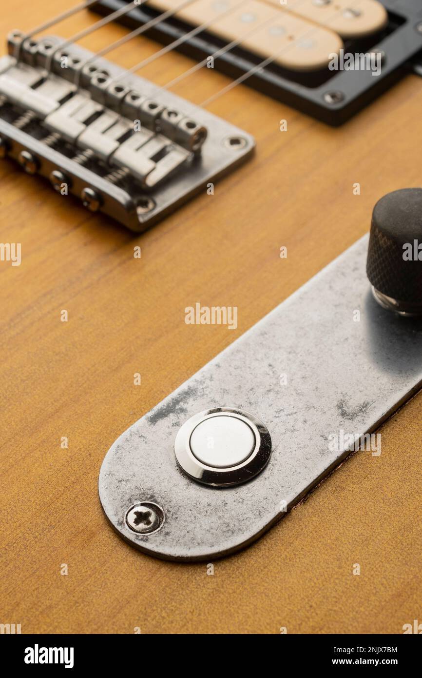 Killswitch button mounted on the control plate of an electric guitar