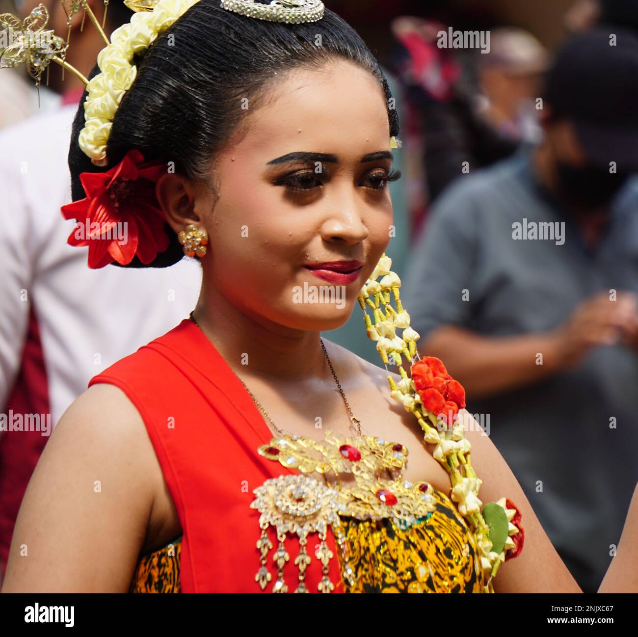 Indonesian with a traditional javanese cloth on 1800 chocolate ketupat