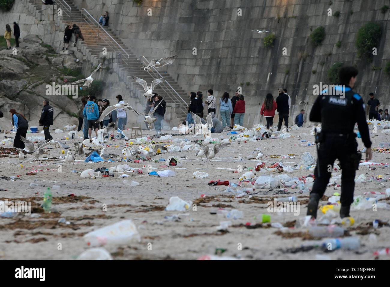 A Local Police officer among the remains of garbage from the ...