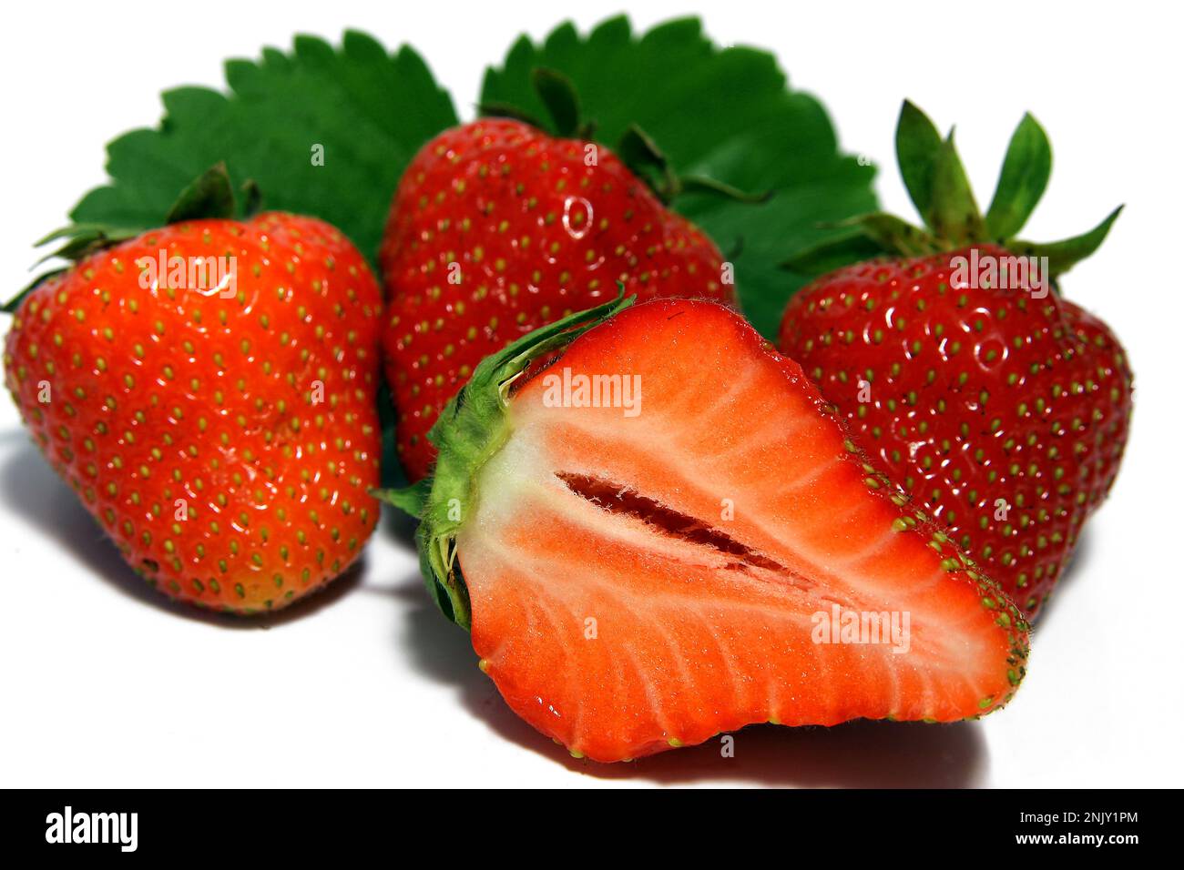 hybrid strawberry, garden strawberry (Fragaria x ananassa, Fragaria ananassa), fresh strawberries, halved, cutout Stock Photo