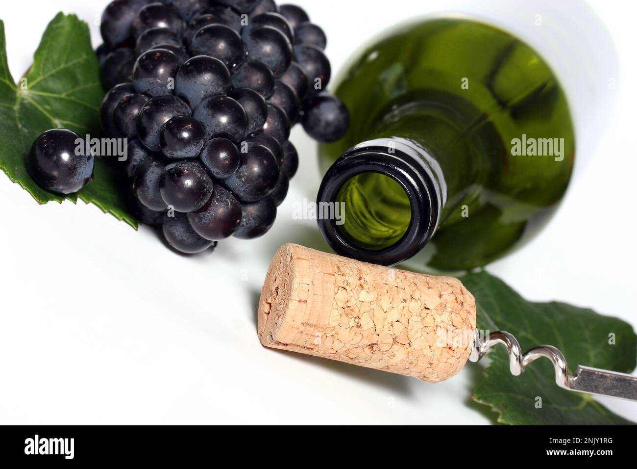 empty wine bottle with cork, leaf and grapes, cutout Stock Photo