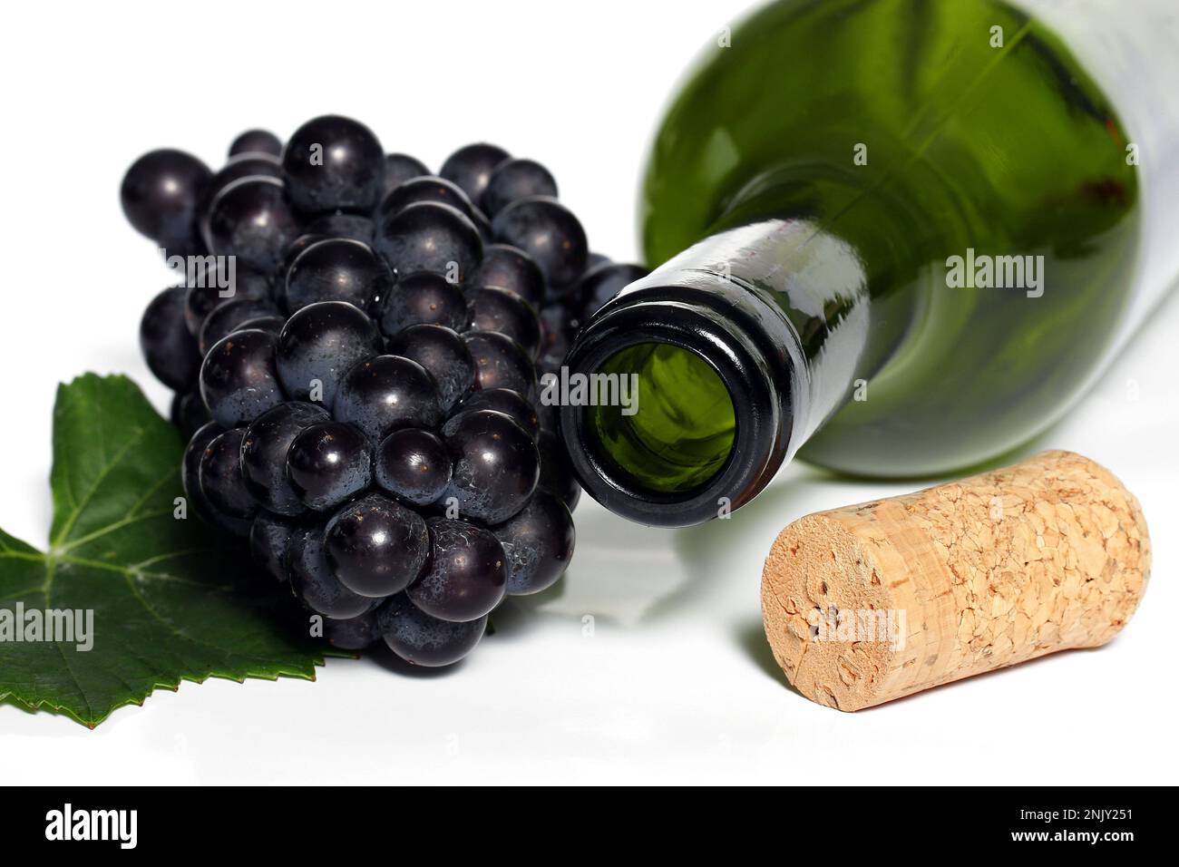 empty wine bottle with cork, leaf and grapes, cutout Stock Photo