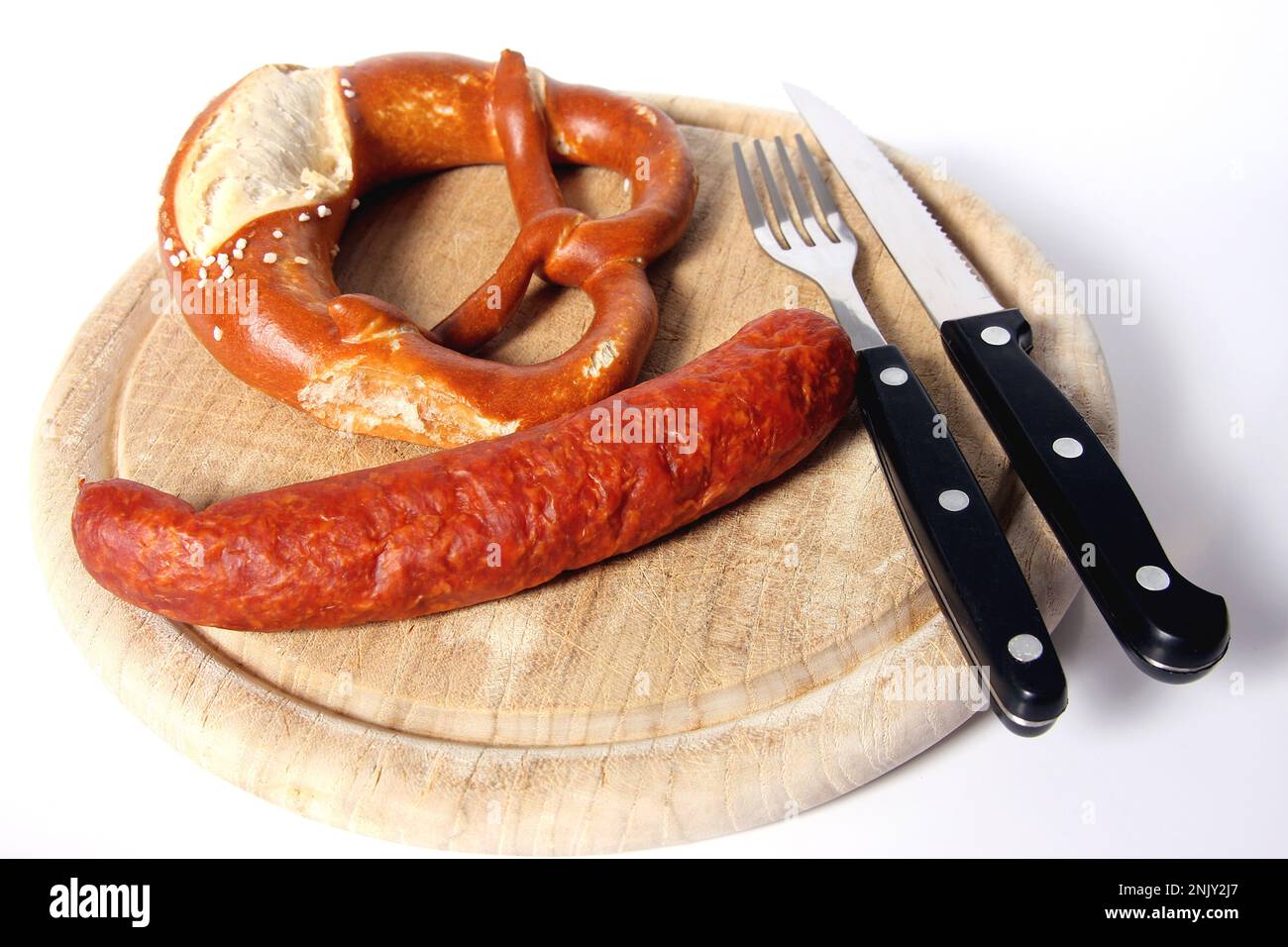 wooden plate with pretzel and mettwurst Stock Photo