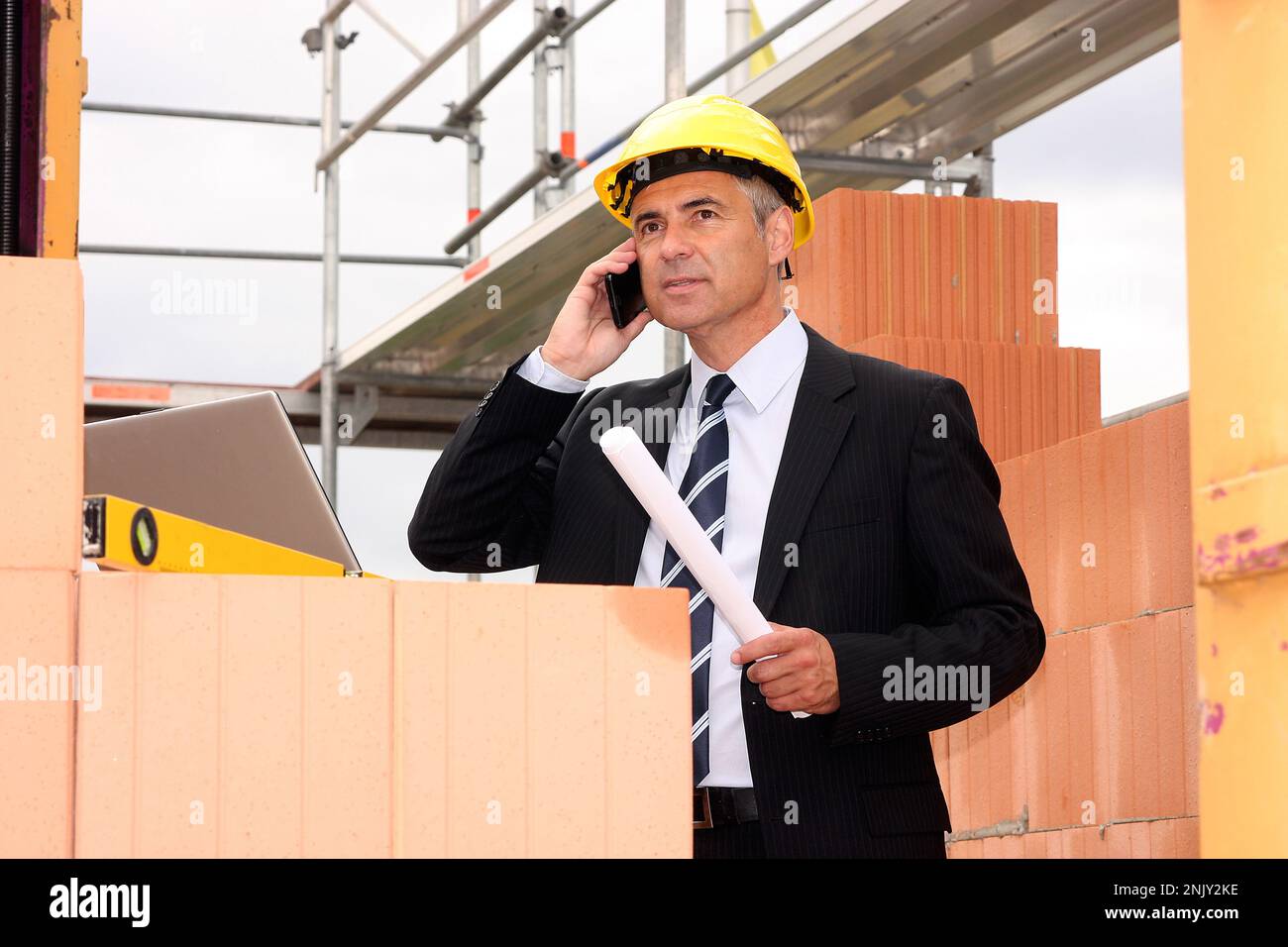 architect on the phone at the building site Stock Photo
