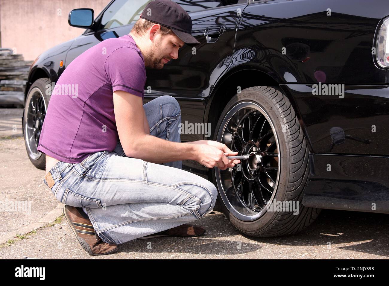 tire change, young man changes winter tyres to sommer tyres, series