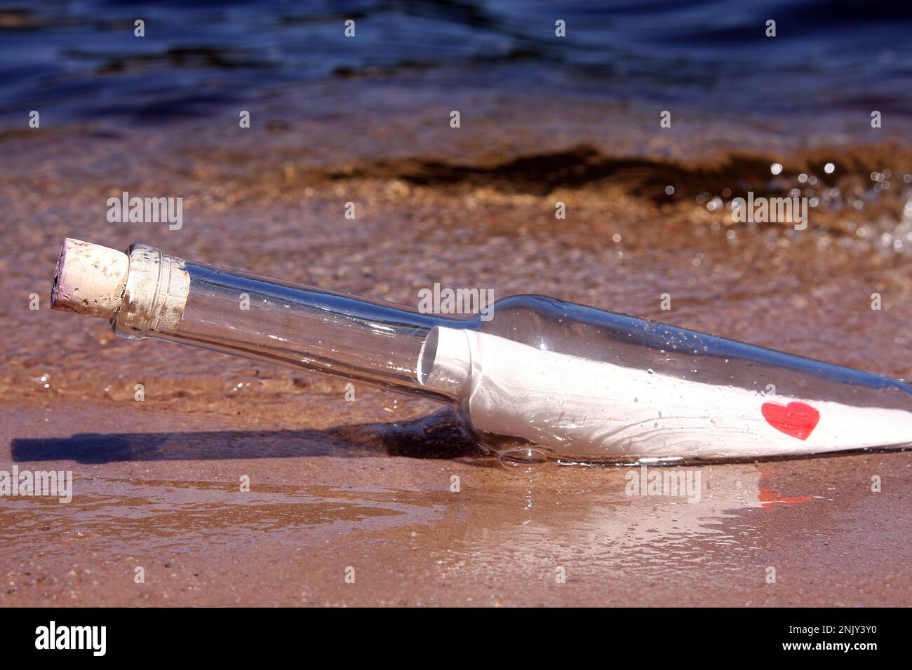 love letter in in a bottle, washed up on a beach Stock Photo