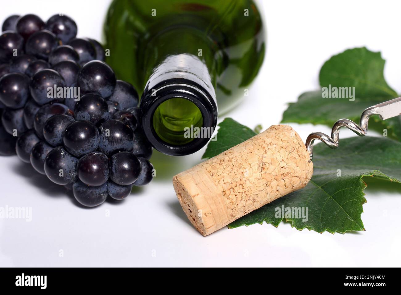 empty wine bottle with cork, leaf and grapes, cutout Stock Photo