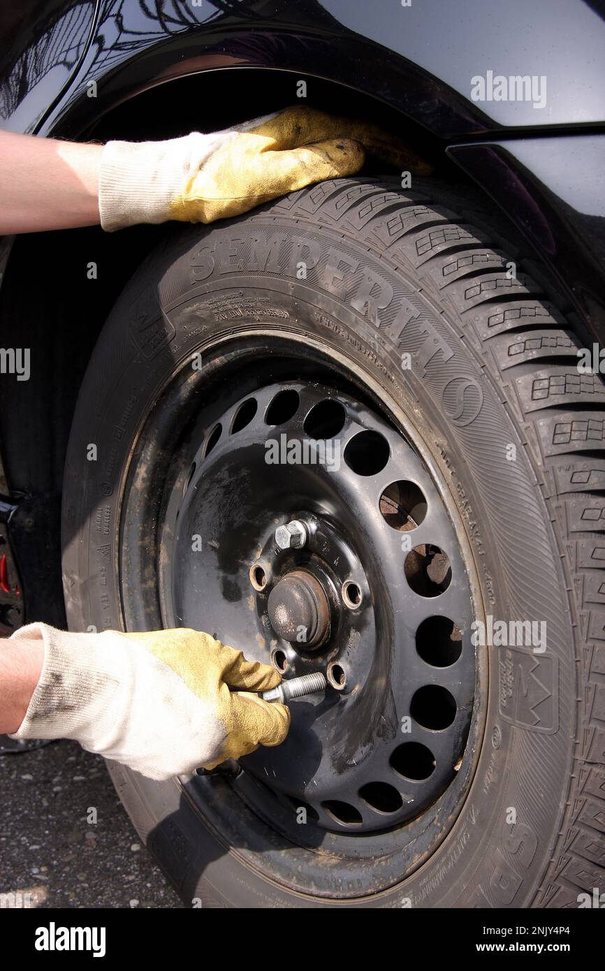 tire change, young man changes sommer tyres to winter tyres, series