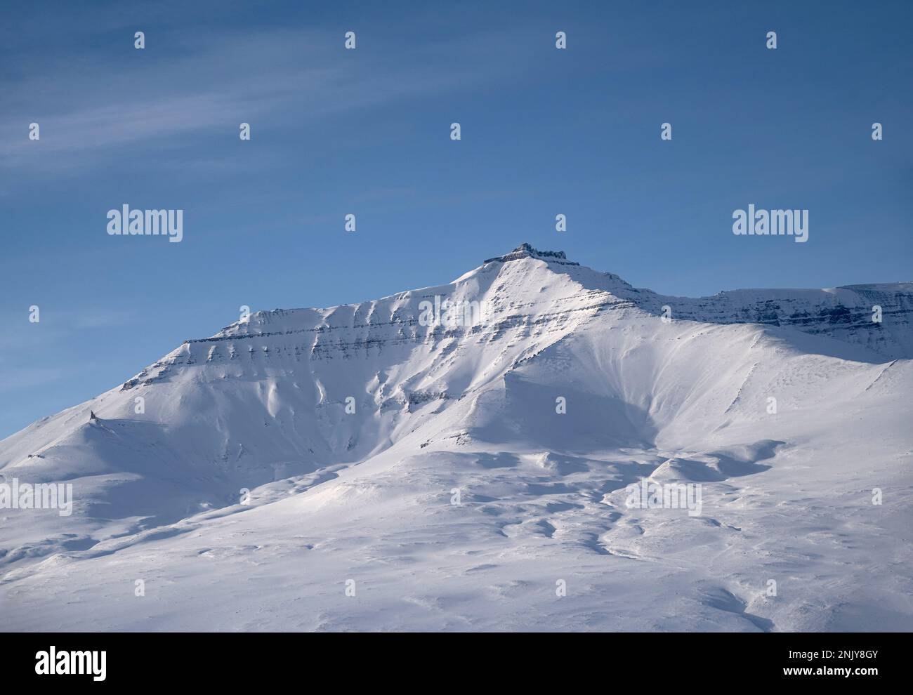 Snow on the mountains above Qaarsut village in west Greenland Stock Photo