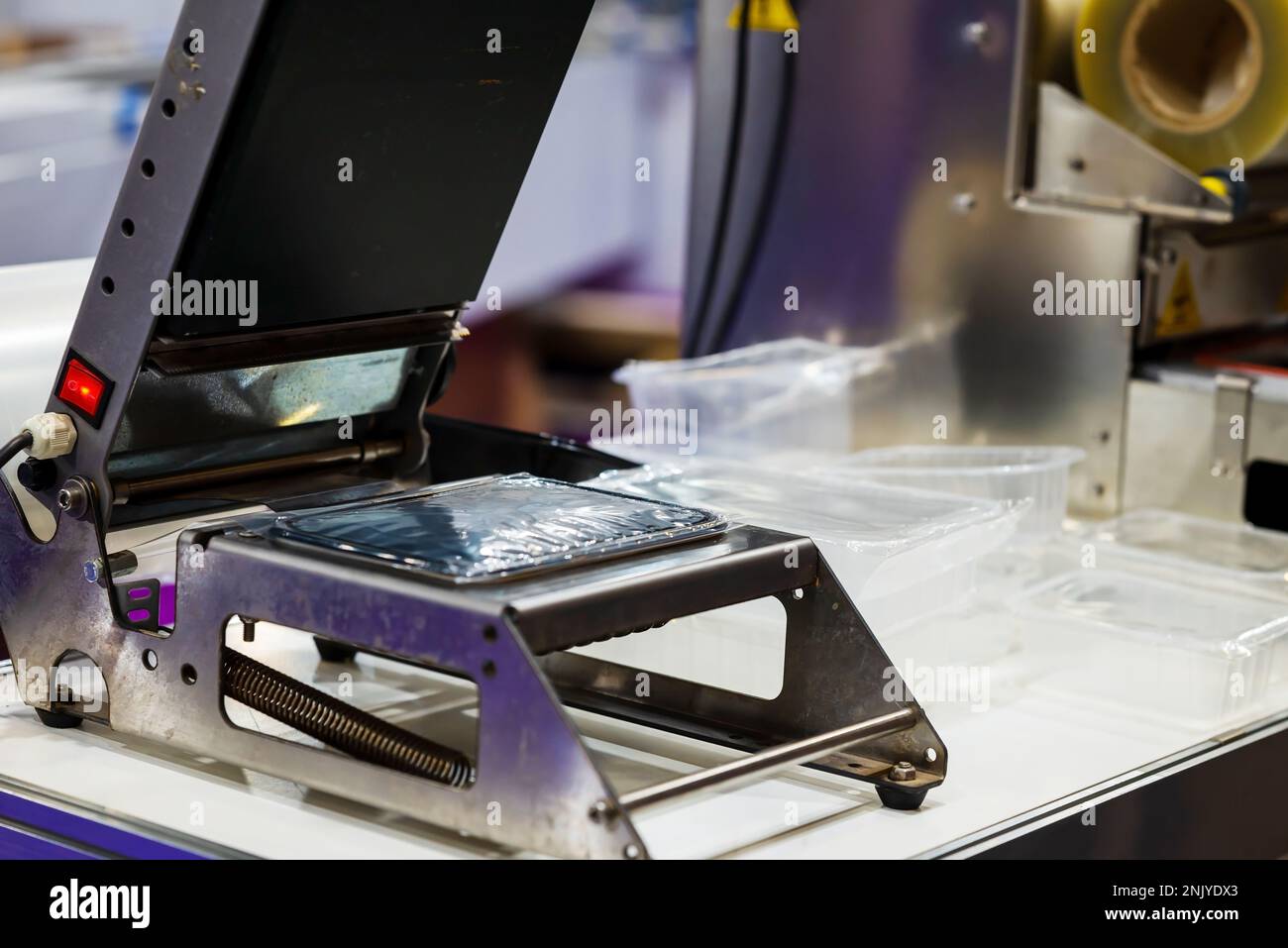 Apparatus for sealing plastic boxes with foil. The concept of