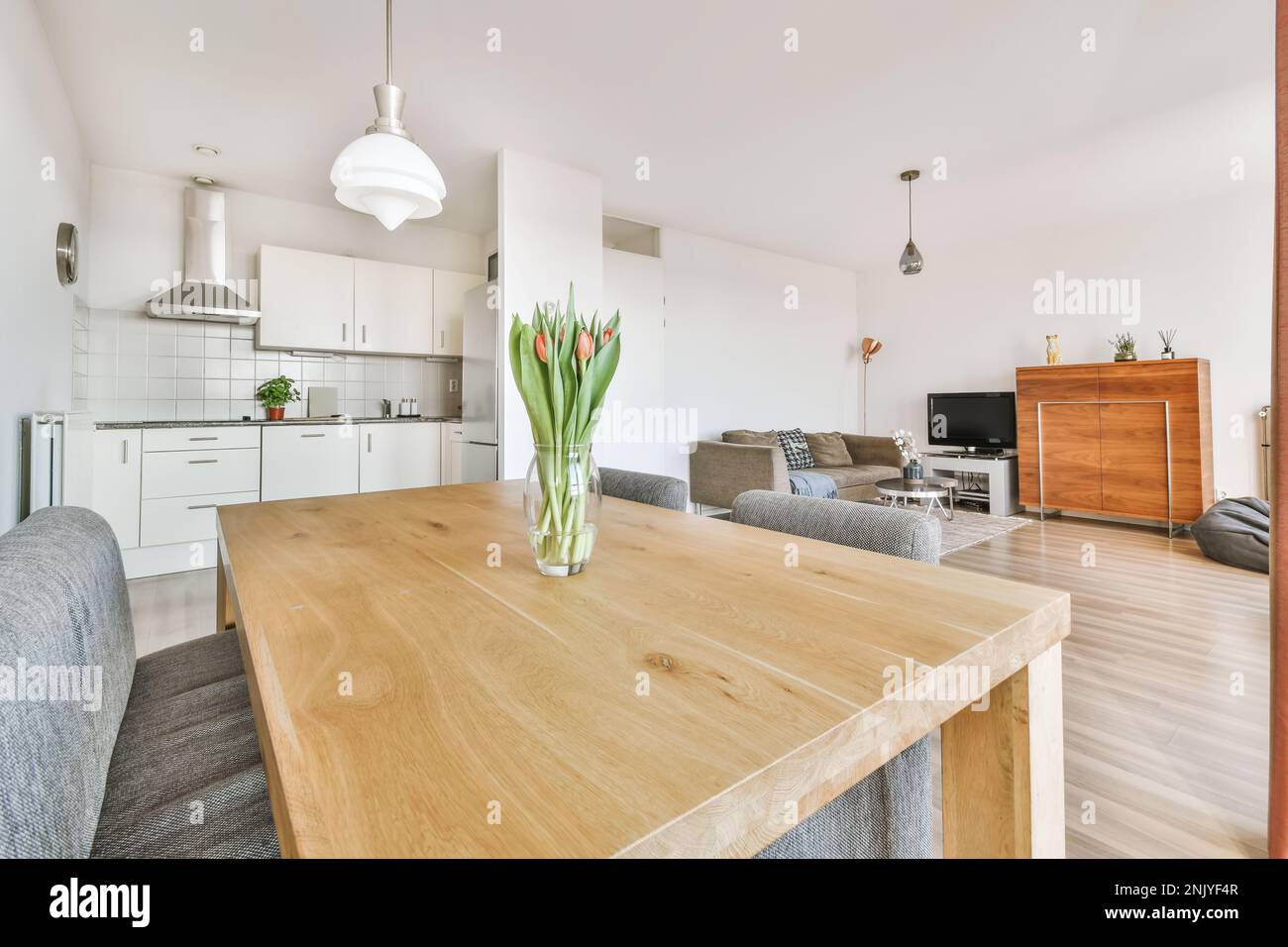 Interior of modern open plan apartment with kitchen and dining area ...