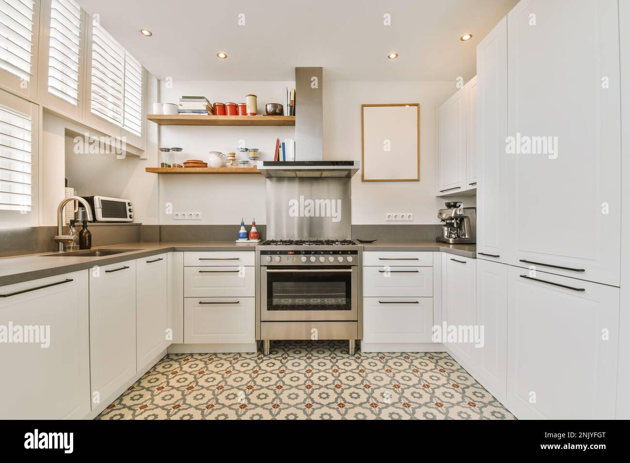 View of Interior of modern kitchen with cabinets and built in appliances in ...