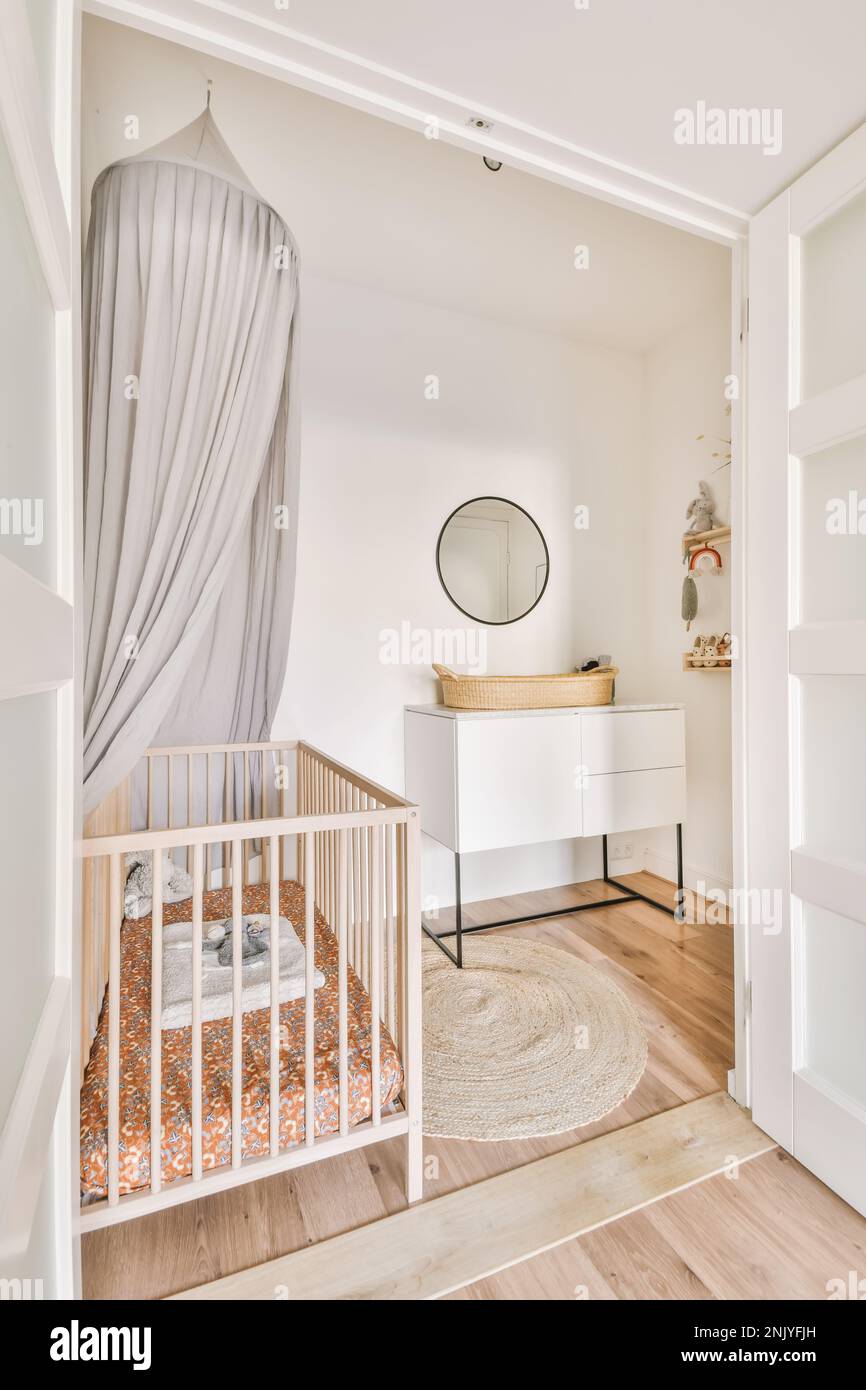 Interior design of modern nursery room in pastel colors with gray