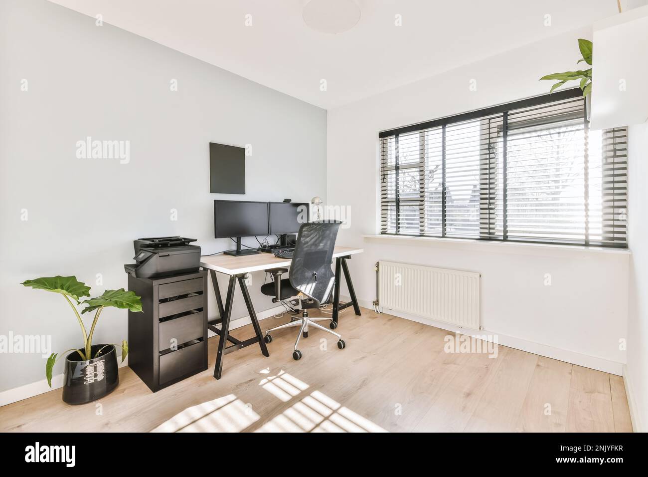 Interior design of modern home office with wooden table desktops and