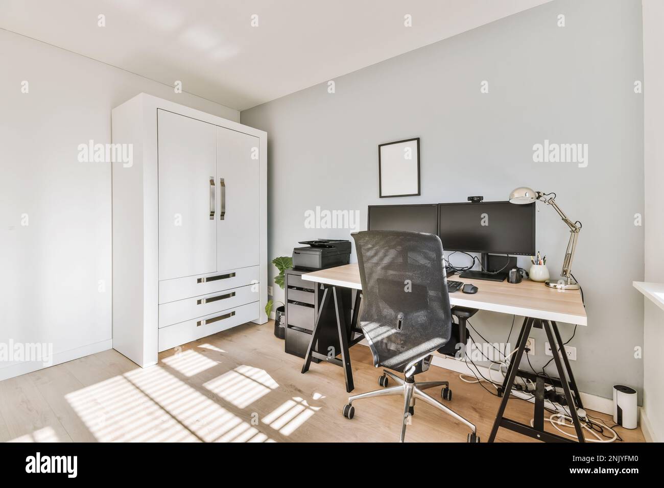 Interior design of modern home office with wooden table desktops and