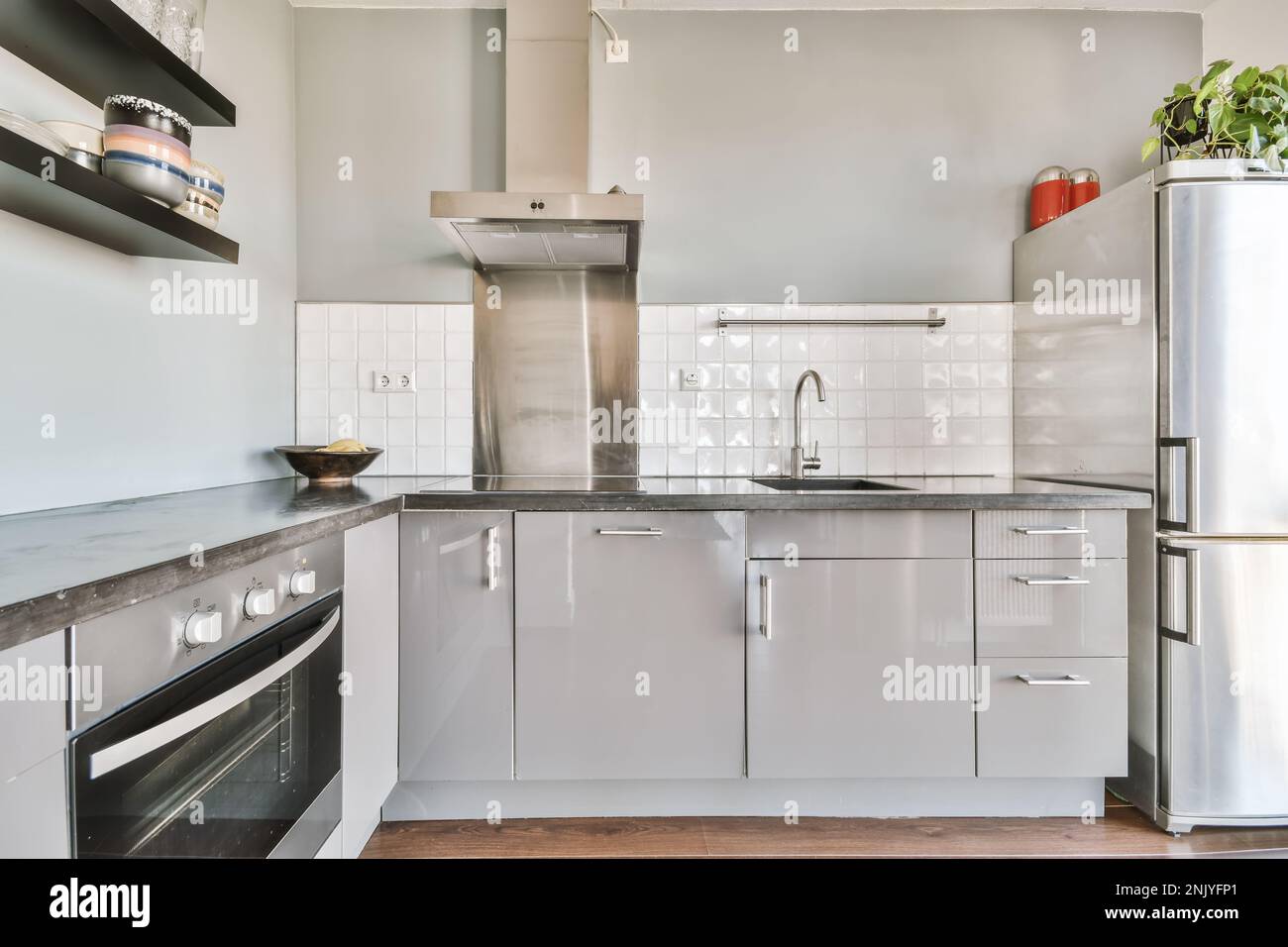 Interior design of contemporary kitchen with gray cupboards marble