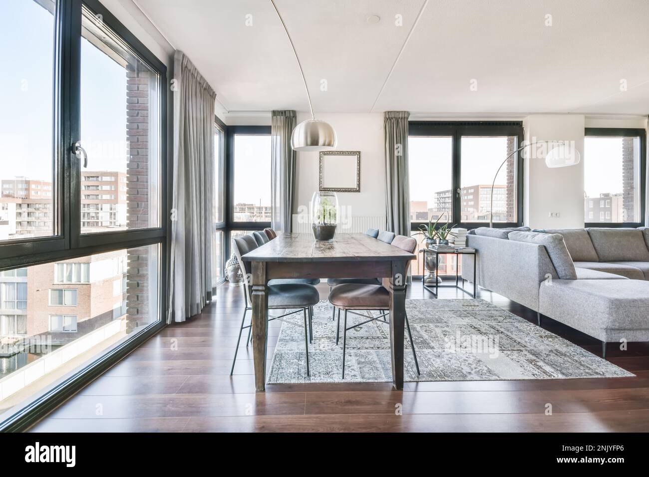 Interior design of spacious living room with dining table and chairs