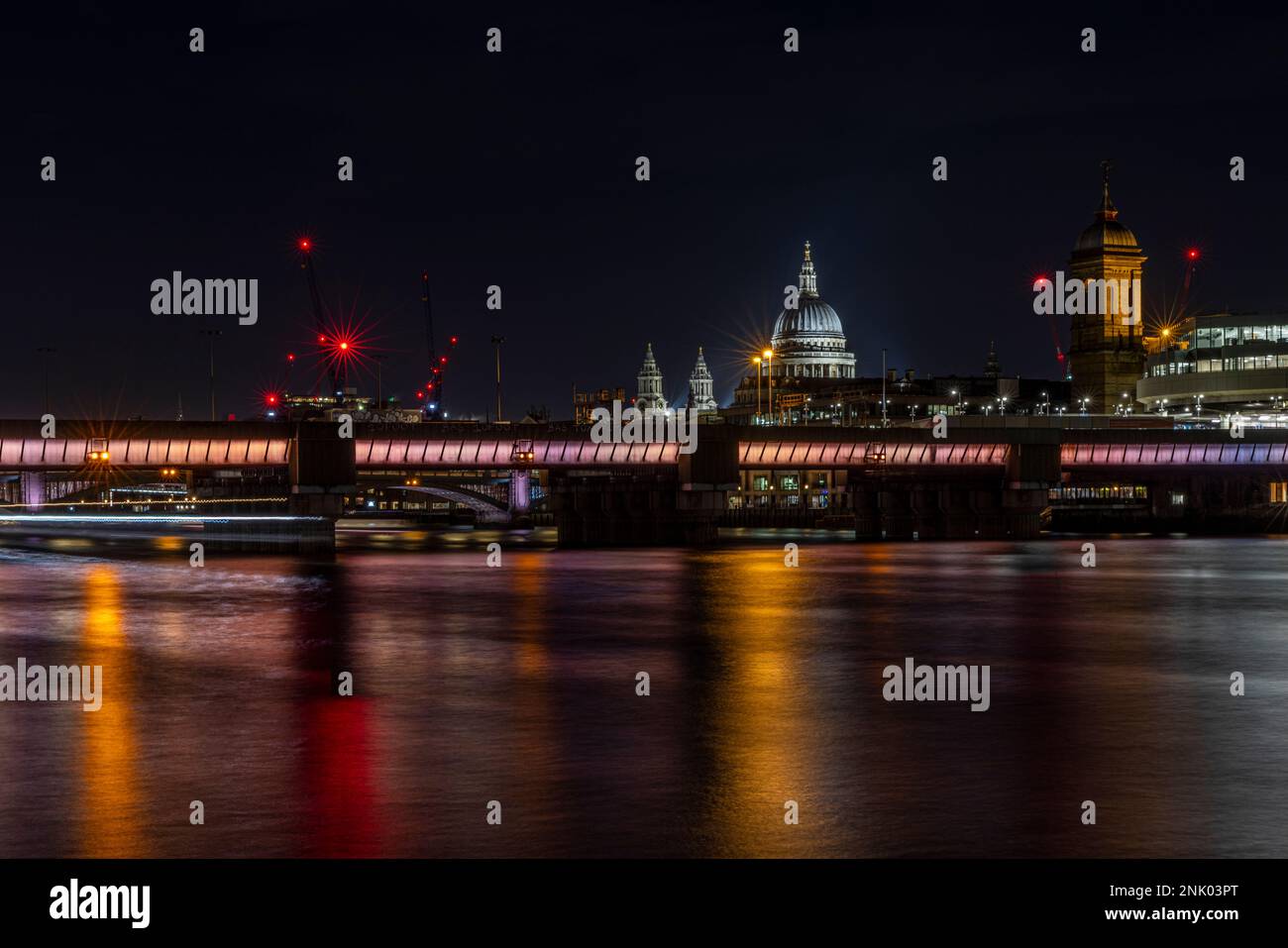 River Thames, Cannon Street Railway Bridge, St Paul's Cathedral and the City at night, London, England, UK Stock Photo