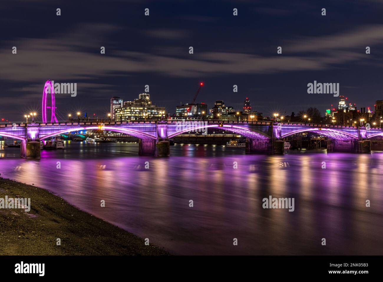 River Thames at low tide and Lambeth Bridge at night, London, England, UK Stock Photo