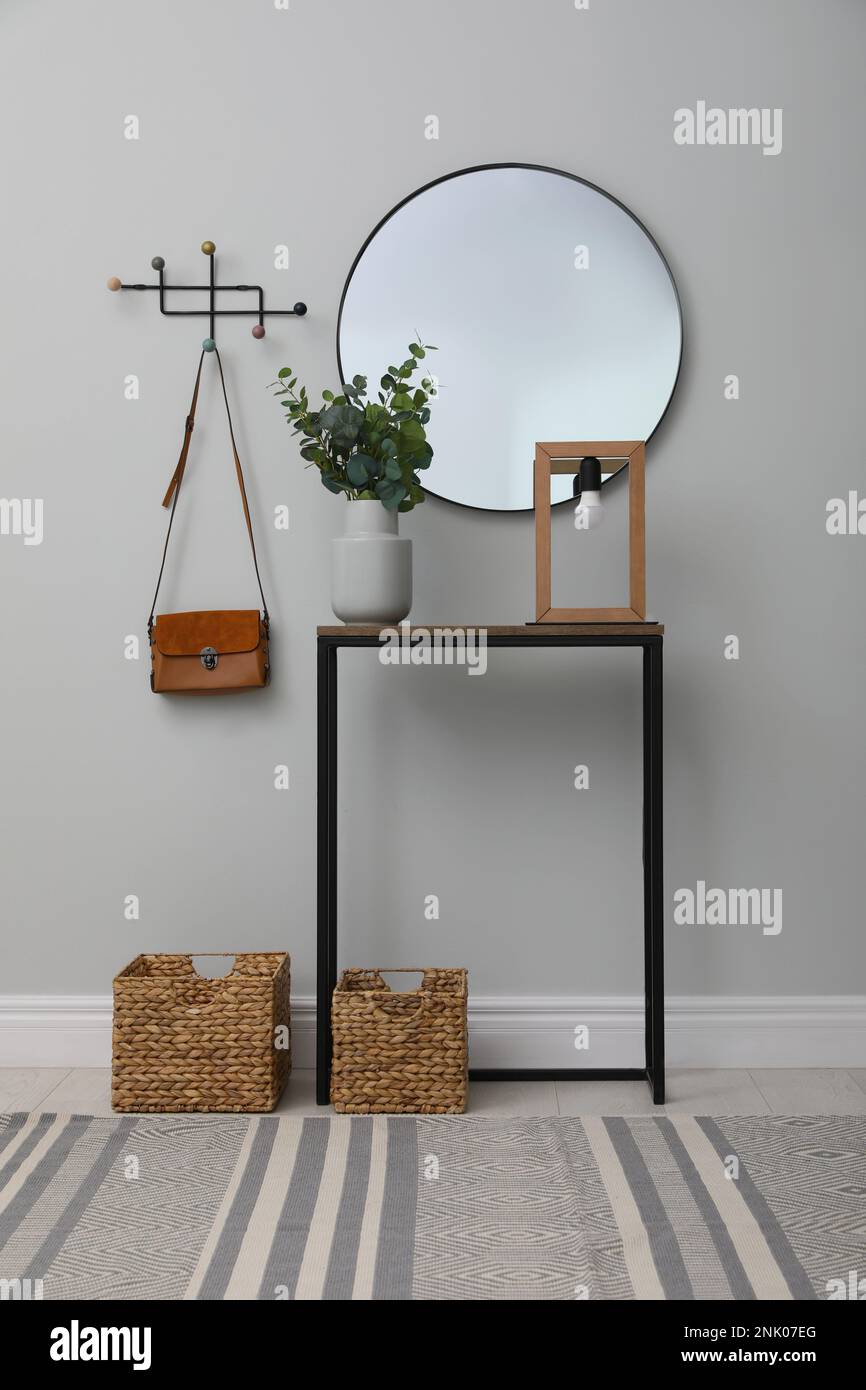 Light hallway with stylish console table and mirror. Interior design ...