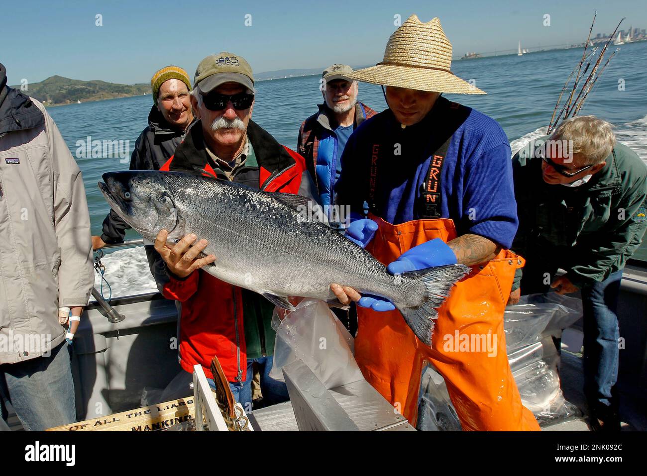 Norm Steiner, (left) shows off the big catch of the day, a 18-20 pound  Chinook (king) salmon, as the sport fishing boat, Hog Heaven returns to  Sausalito with a full load of
