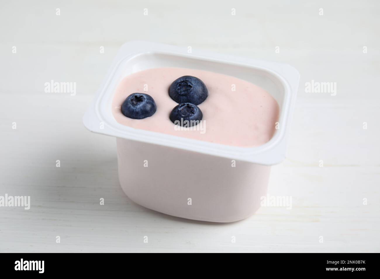 yogurt with fresh garden berries and cereals in reusable picnic