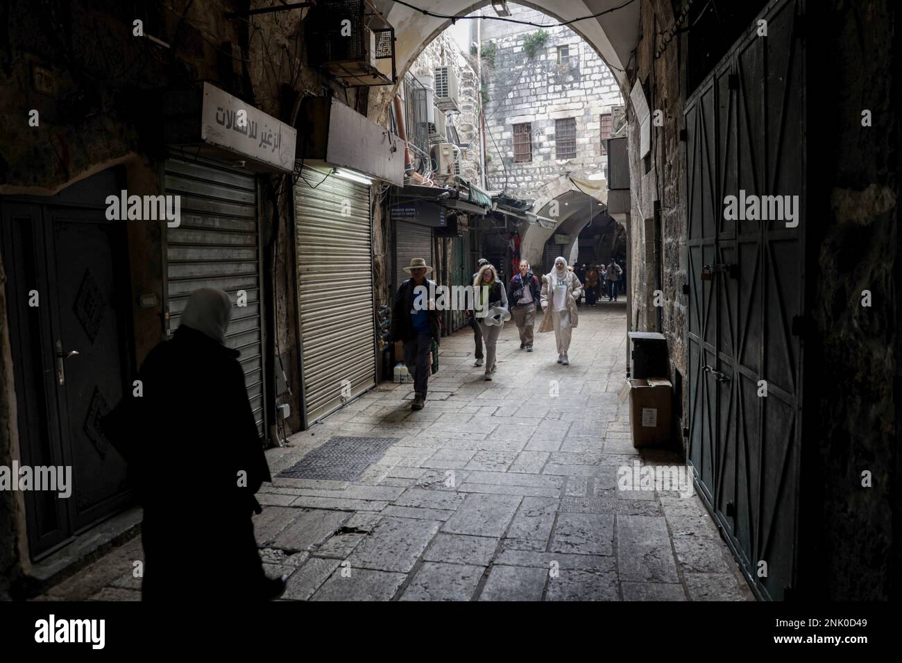 Jerusalem, Israel. 22nd Feb, 2023. Palestinians walk past closed shops