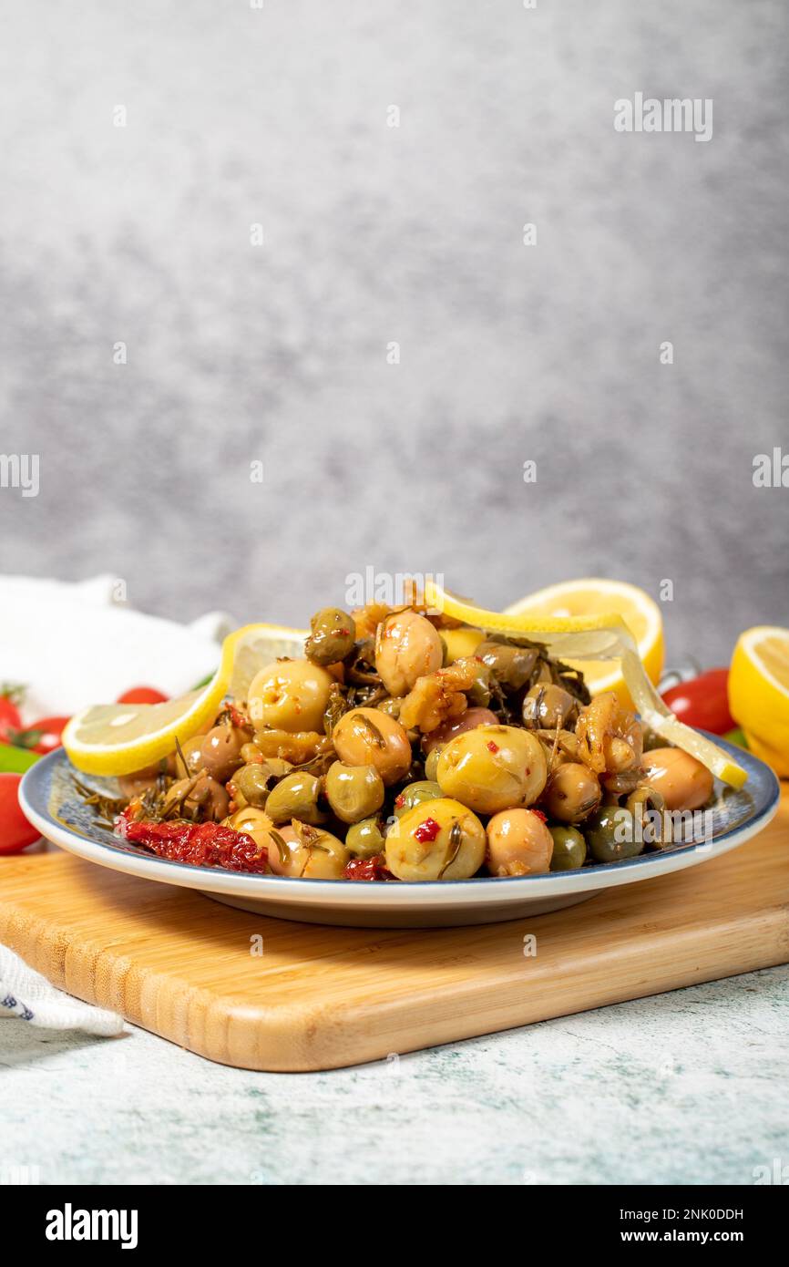 Special mixed olives prepared with green olives, dried red peppers, sun