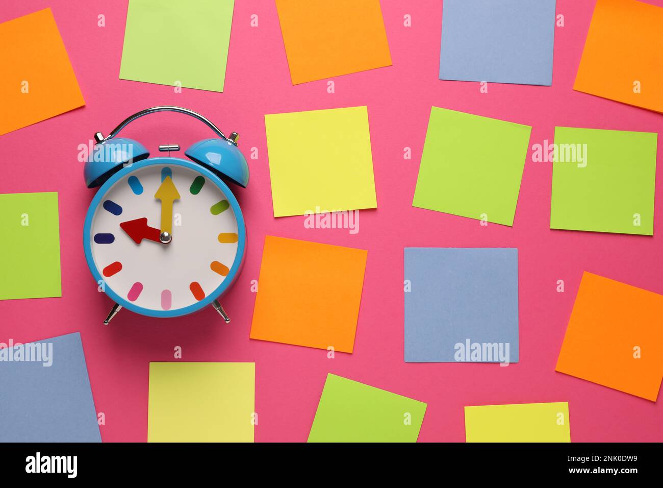 Alarm clock and blank reminder notes on pink background, flat lay Stock Photo