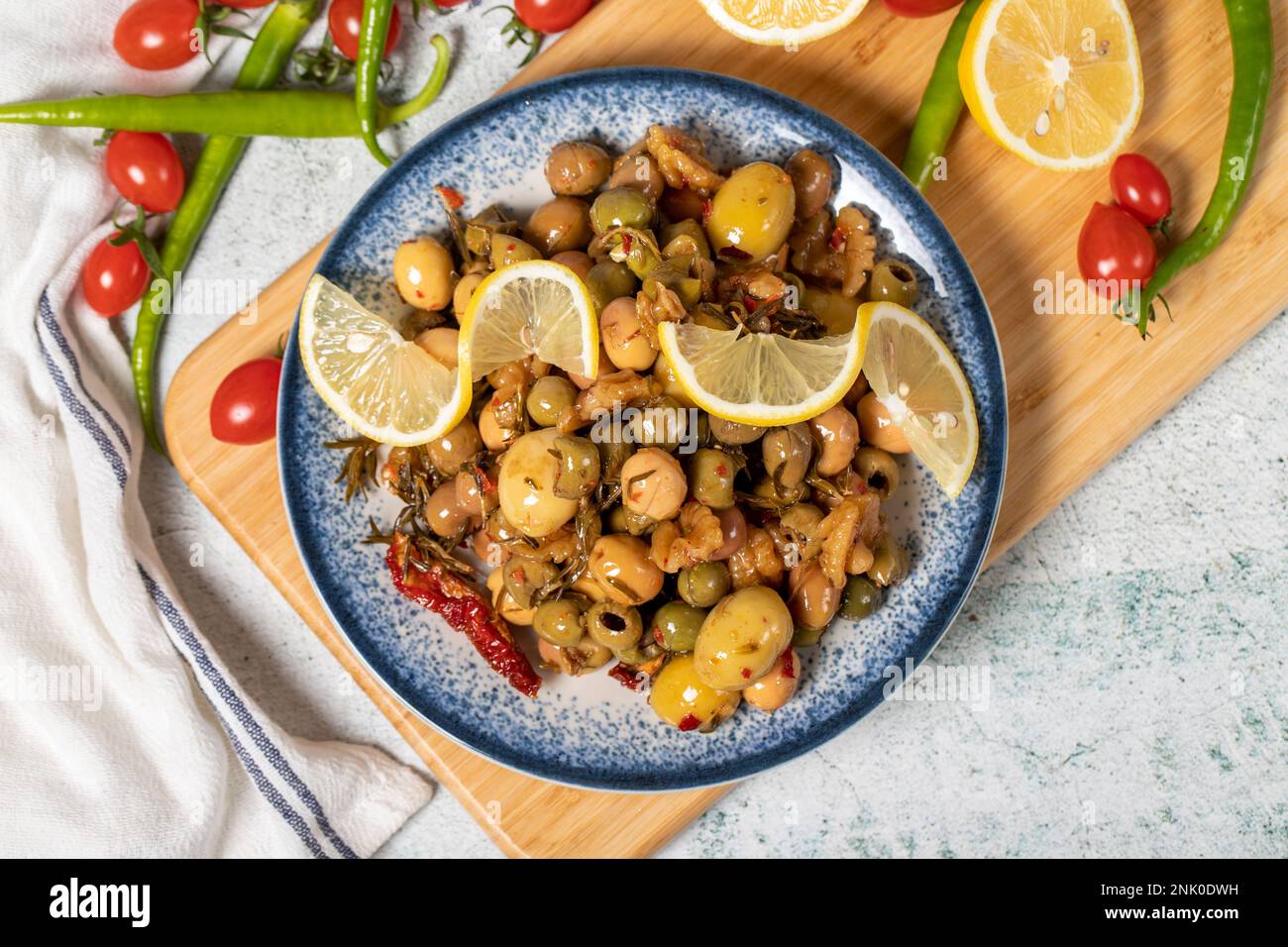 Special mixed olives prepared with green olives, dried red peppers, sun