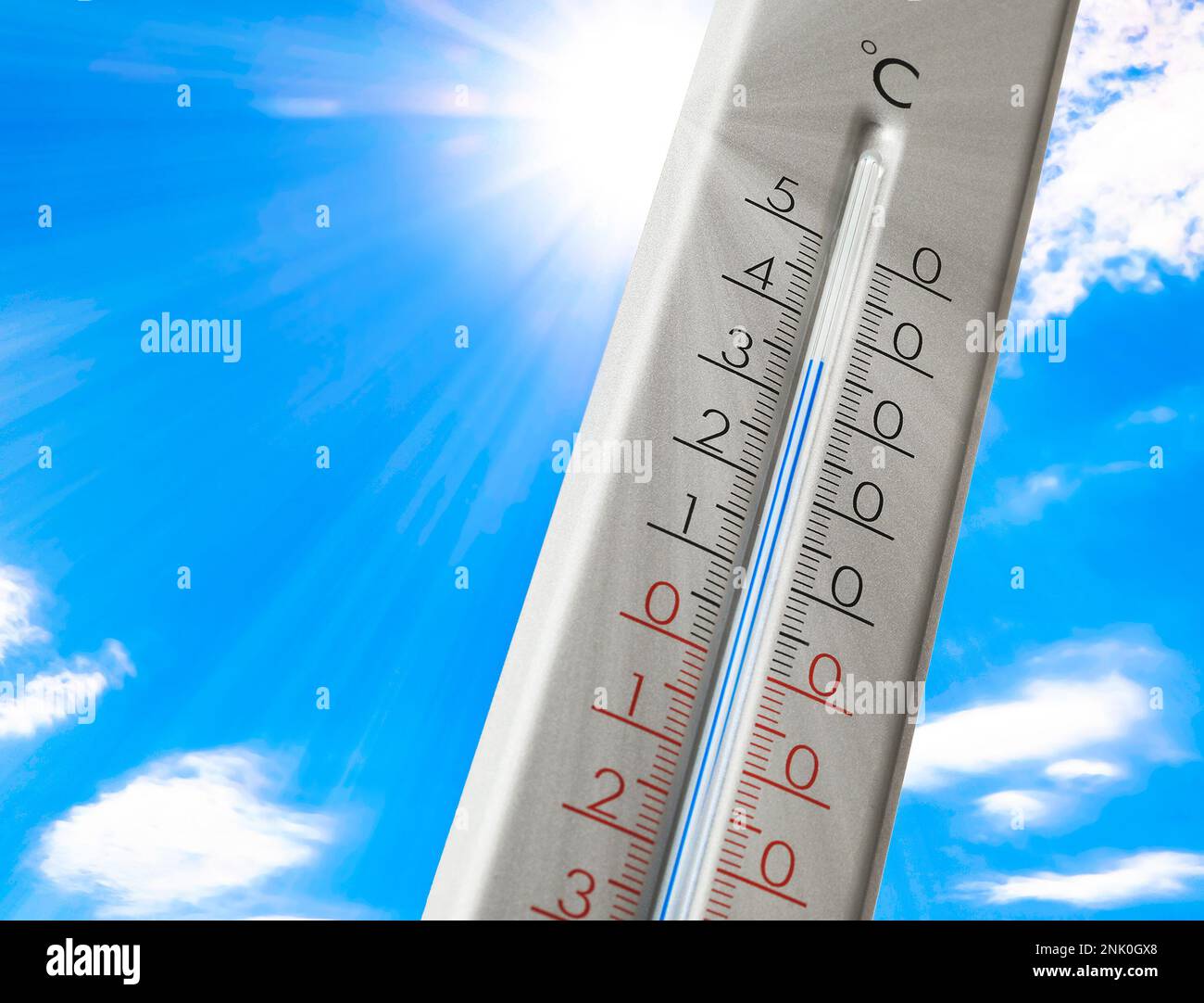 Weather thermometer with high temperature outdoors on hot sunny day