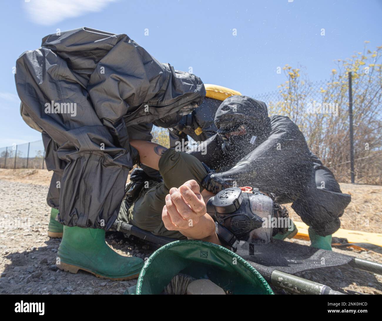 U.S. Marines assigned to 1st Marine Division conduct a wash down as part of the simulated decontamination process during scenario-based training on Camp Pendleton, California, Aug. 9, 2022. CBRN is responsible for conducting training and reconnaissance, chemical detection identification, biological agent collection and sampling, decontamination of personnel, equipment, and casualties and individual protective measures in first aid for unit personnel. Stock Photo