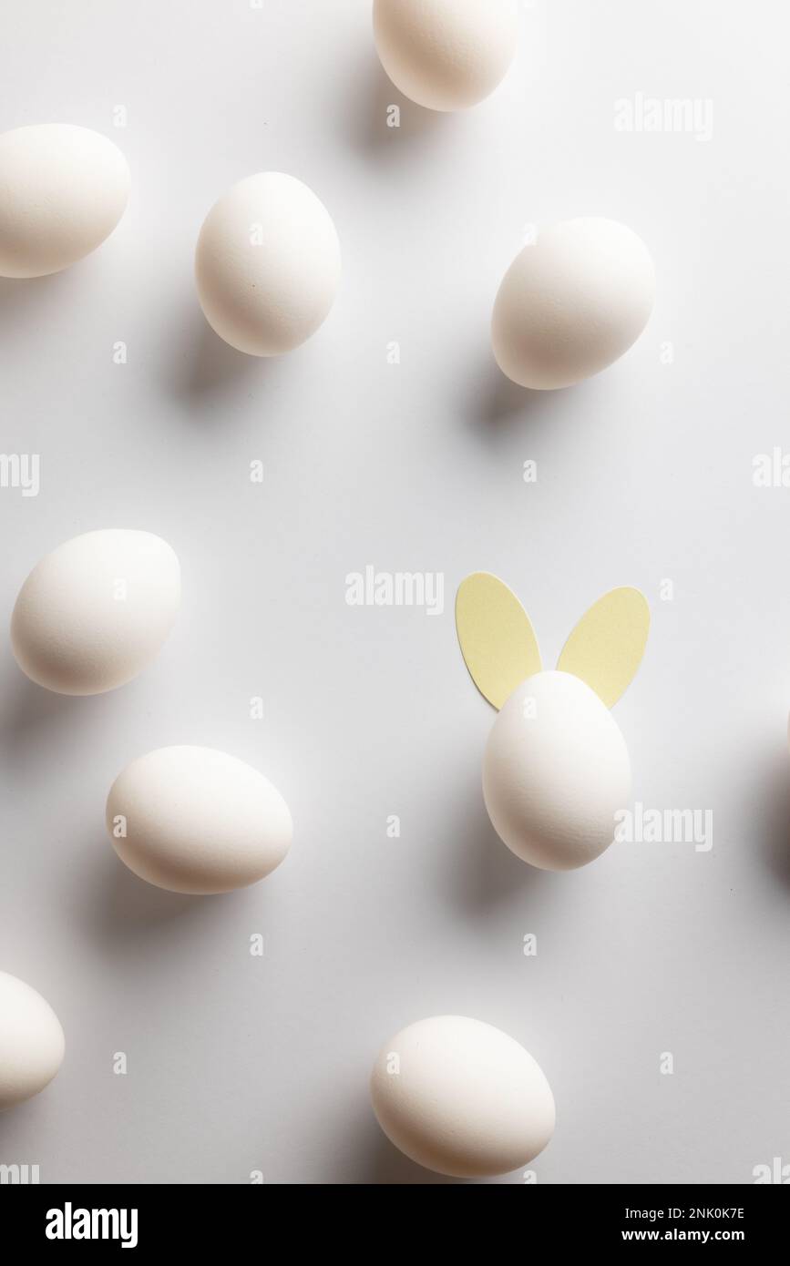 Image of white easter eggs with bunny ears and copy space on white ...