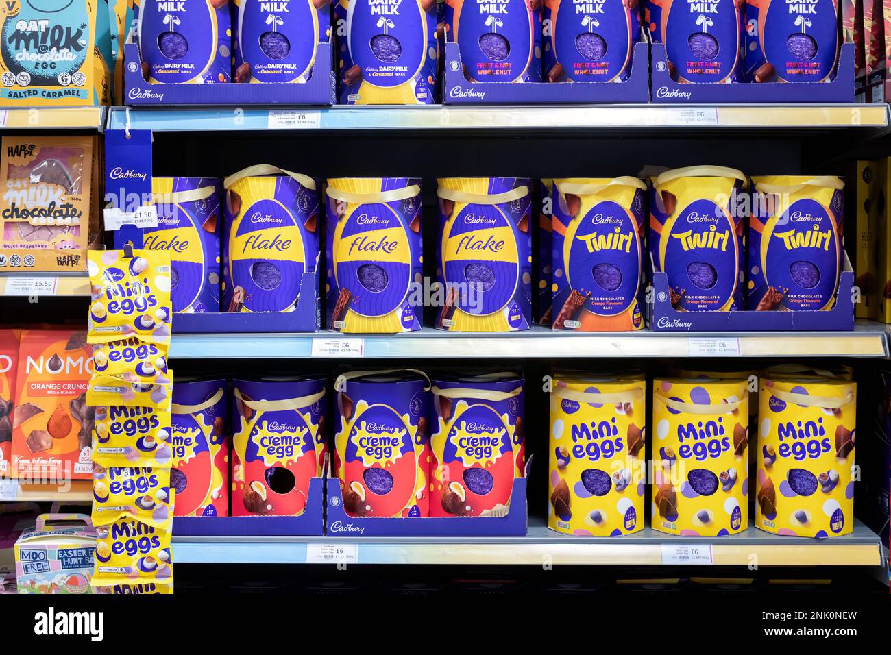UK supermarket shelves filled with Cadbury Easter Eggs. The assortment includes Cadury Flake, Twirl Creme egg and mini Eggs Stock Photo