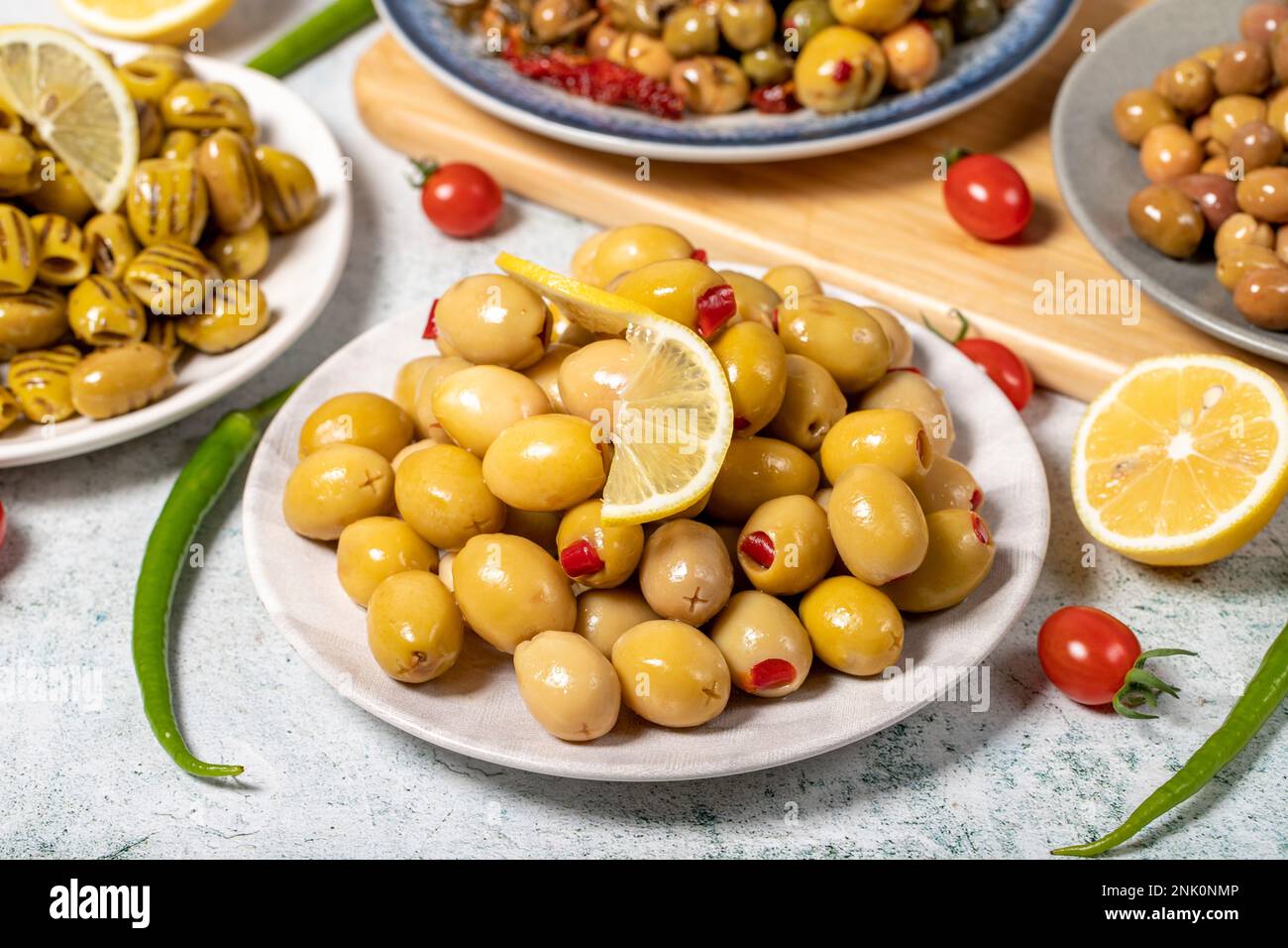 Olive varieties. Assortment of black and green olives on plate on gray background Stock Photo
