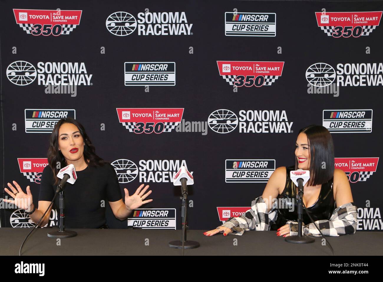 SONOMA, CA - JUNE 12: Professional tag team wrestlers The Bella Twins, Brie  Bella (left) and Nikki Bella (right) during a pre race press conference for  the NASCAR Cup Series Toyota/Save Mart