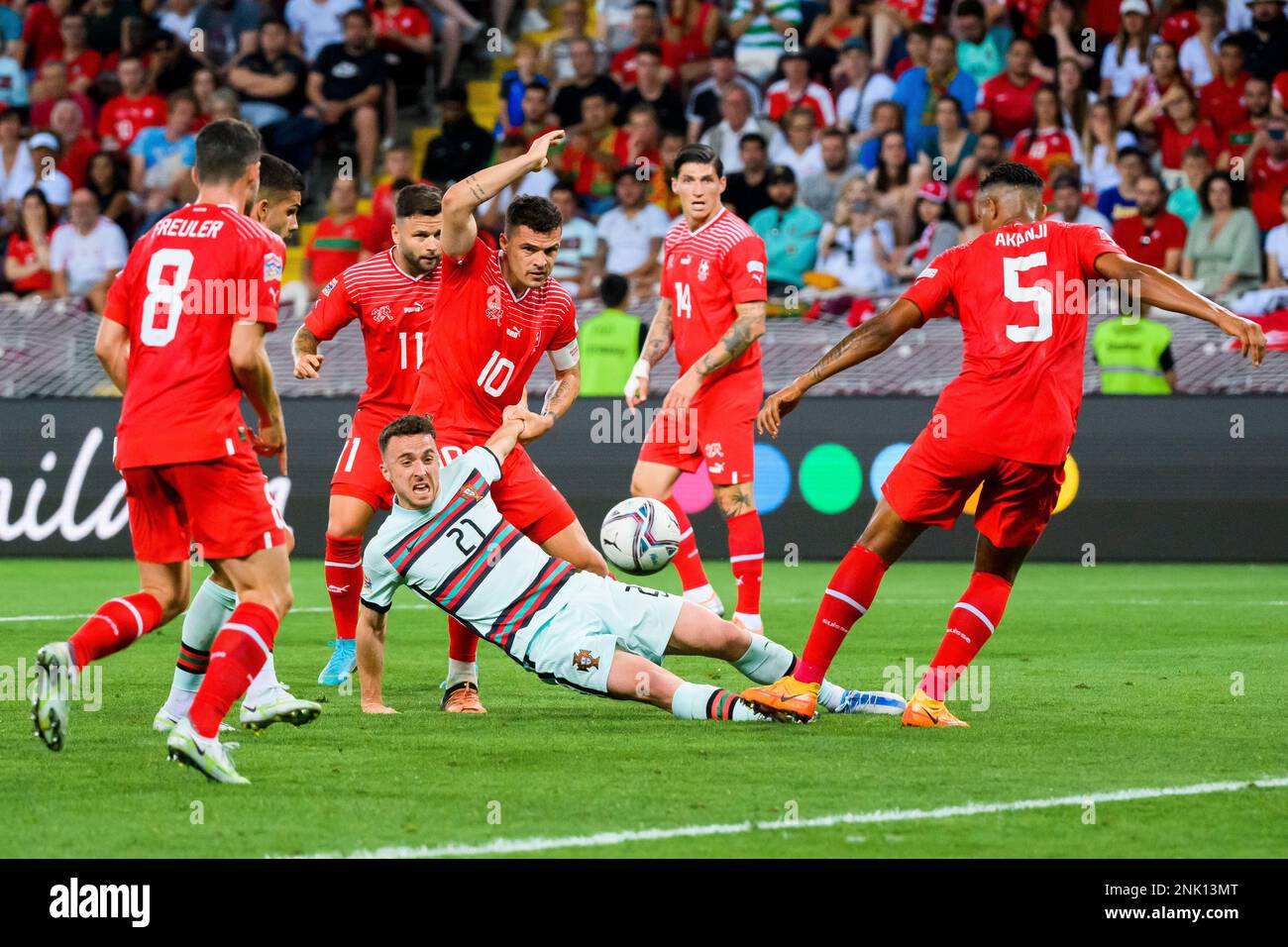 Portugal's forward Diogo Jota, center, fights for the ball with