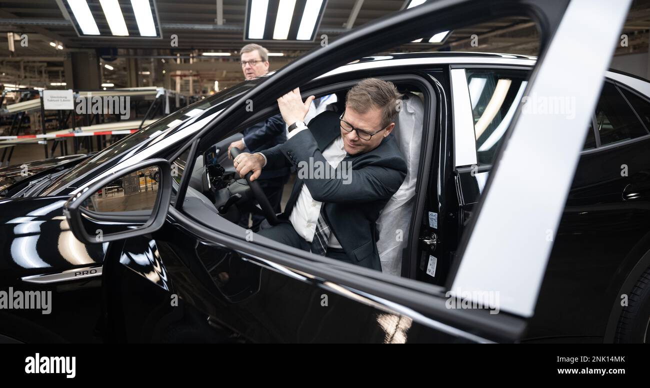 23 February 2023, Saxony, Zwickau: Thomas Edig (l), Managing Director Human Resources Volkswagen Saxony, and Carsten Schneider (SPD), Minister of State and Federal Government Commissioner for Eastern Germany, get out of an ID.5 at the Volkswagen plant in Zwickau. The Federal Government Commissioner for Eastern Germany visited the plant on Thursday (Feb. 23, 2023). In addition to VW vehicles, cars from the group's Audi and Seat brands also come off the production line at the plant. The vehicles are based on the Modular Electric Toolkit. Volkswagen has converted the site, which employs around 9, Stock Photo