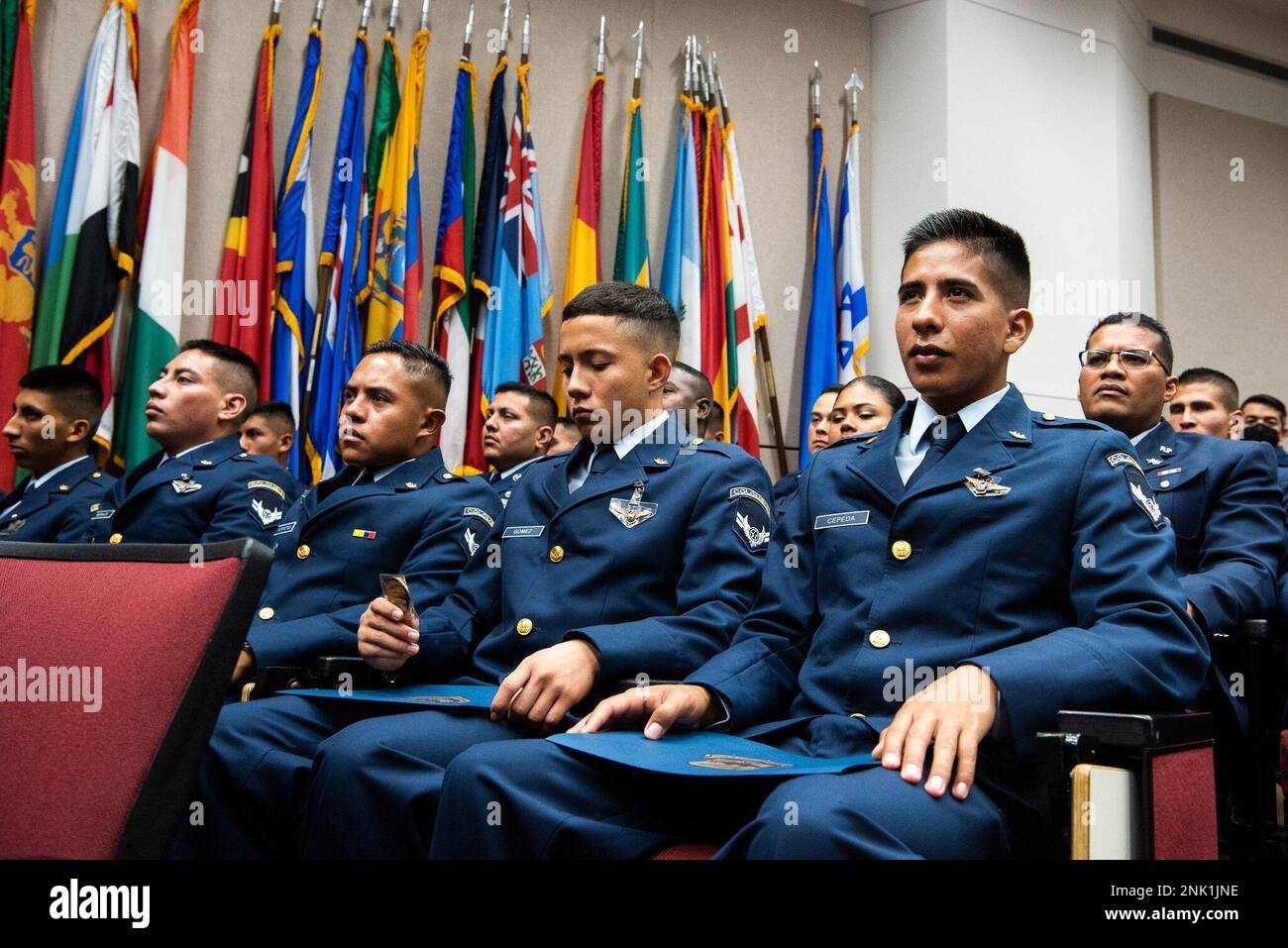 An international military student glances at the coin he received during graduation ceremony for the Inter-American Air Forces Academy, Aug 8, 2022 at Joint Base San Antonio - Lackland. Approximately 200 students from 10 partner nations and the U.S. graduated from IAAFA during B-Cycle graduation. Stock Photo
