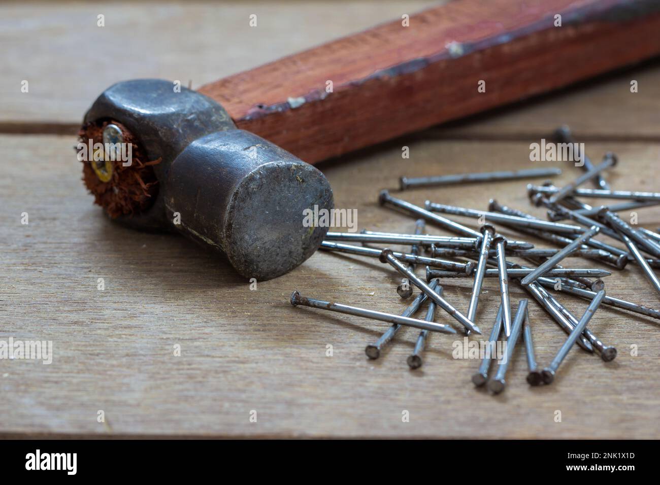 Steel hammer and nails used in wooden work. Bunch of nails along with