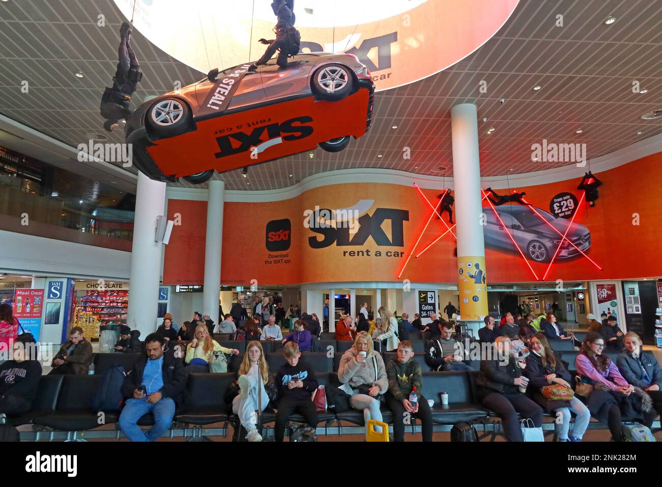 Sixt vehicle lease / rental promotion at Manchester Airport, Its a deal, Its a steal - channelling Mission Impossible Stock Photo