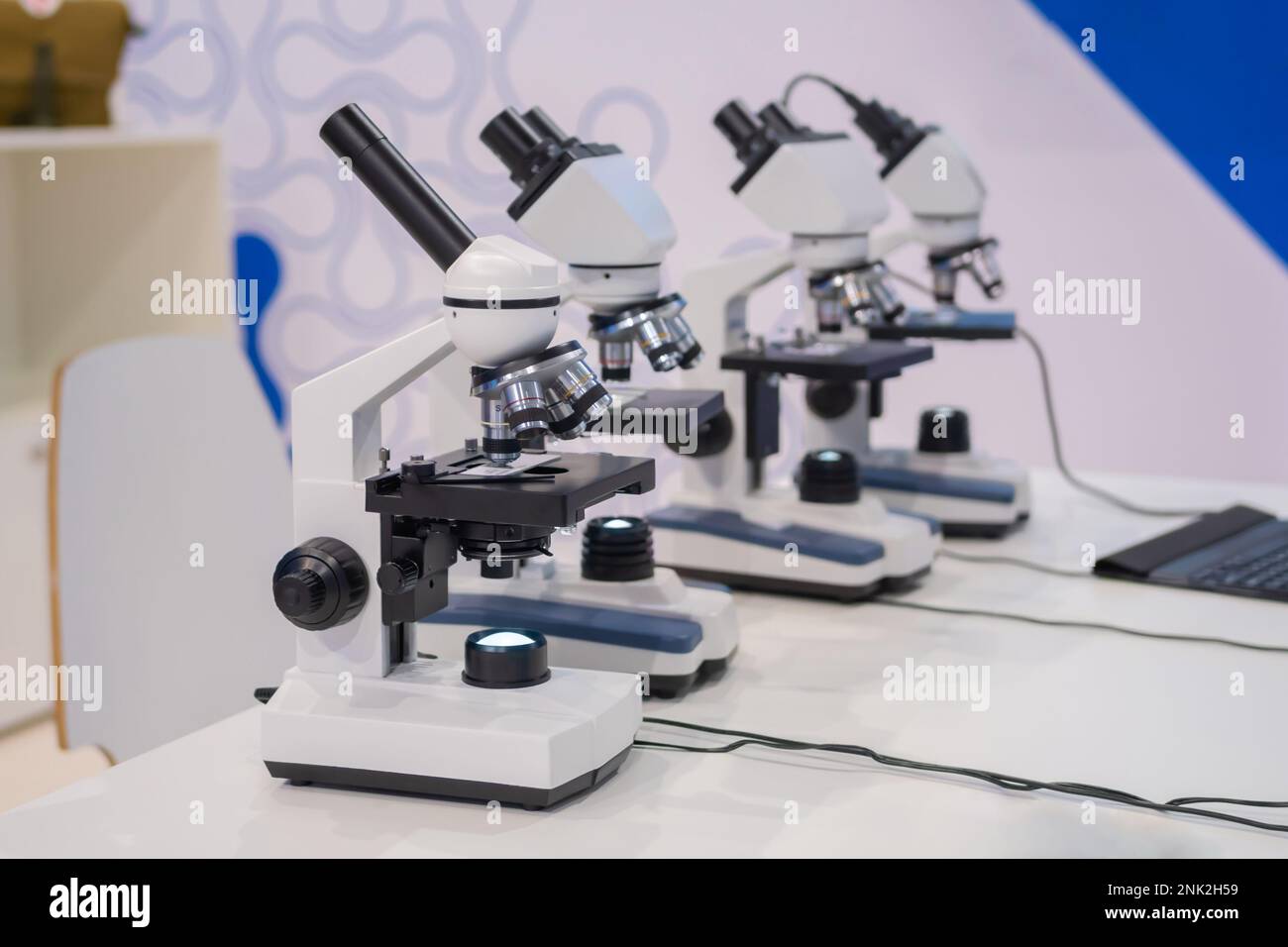 Microscopes on white table at science exhibition - laboratory equipment Stock Photo