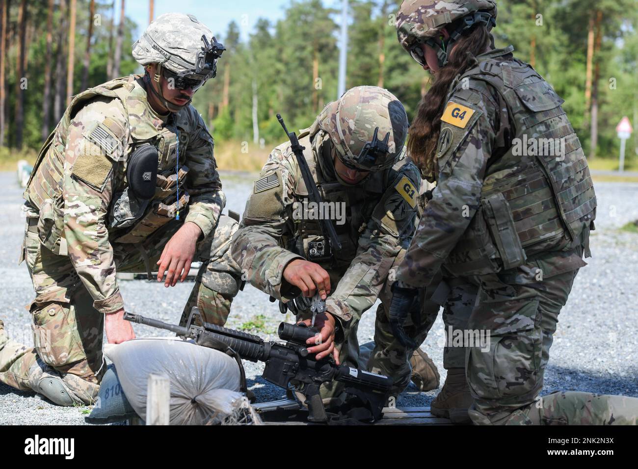 U.S. Army Staff Sgt. Jose Bianchi, center, assigned to 56th Artillery ...