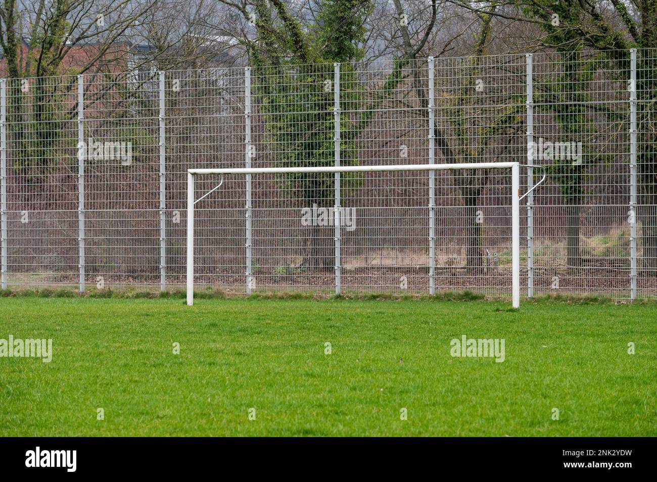 Kessel-Lo, Flemish Brabant, Belgium - Feb 11 2023 - Empty green field and goal of an amateur soccer field Stock Photo