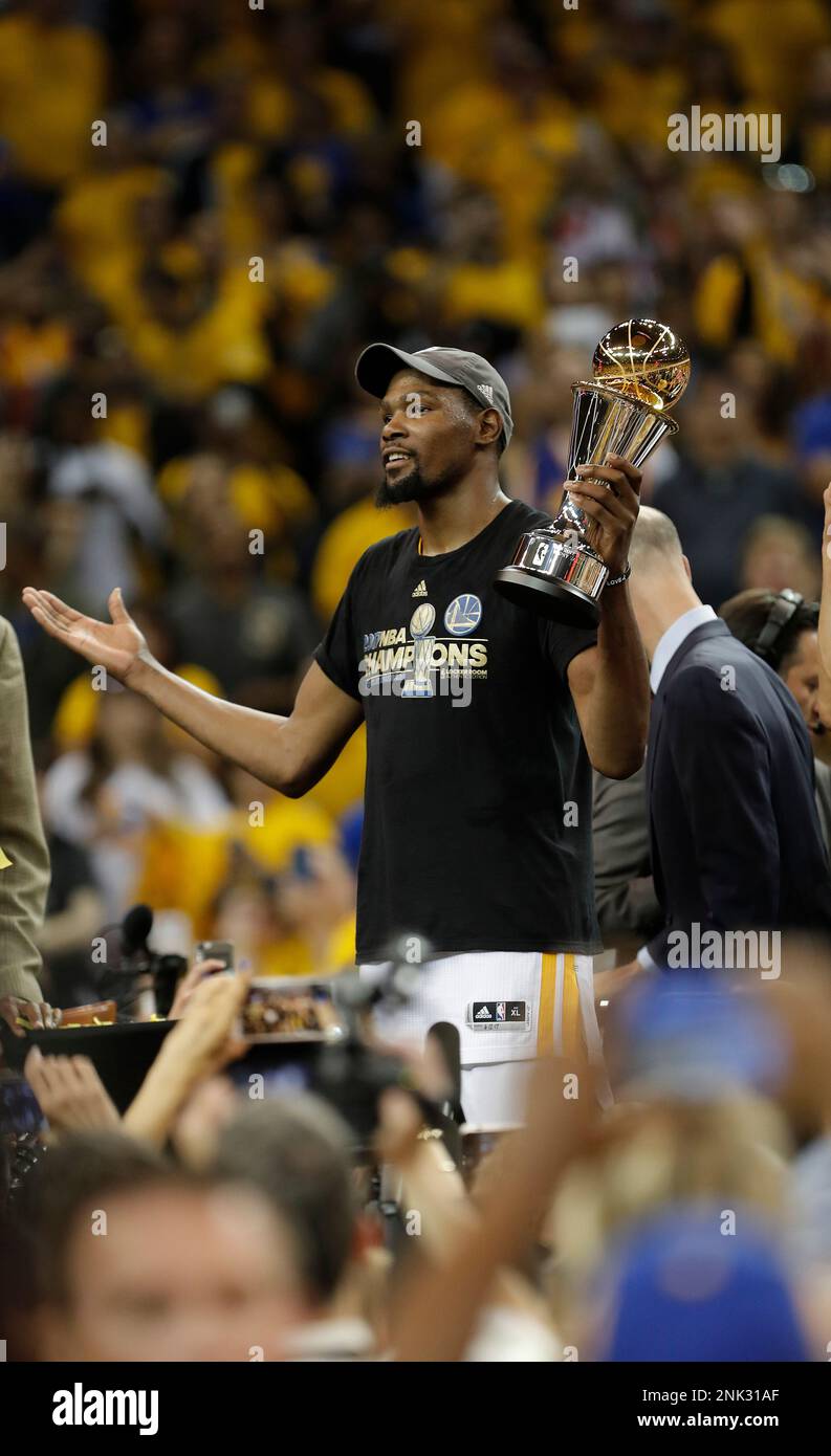 Warriors Kevin Durant with the MVP trophy as the Golden State Warriors beat the Cleveland Cavaliers 129 120 in game 5 of the NBA finals to win the NBA championship at Oracle Arena